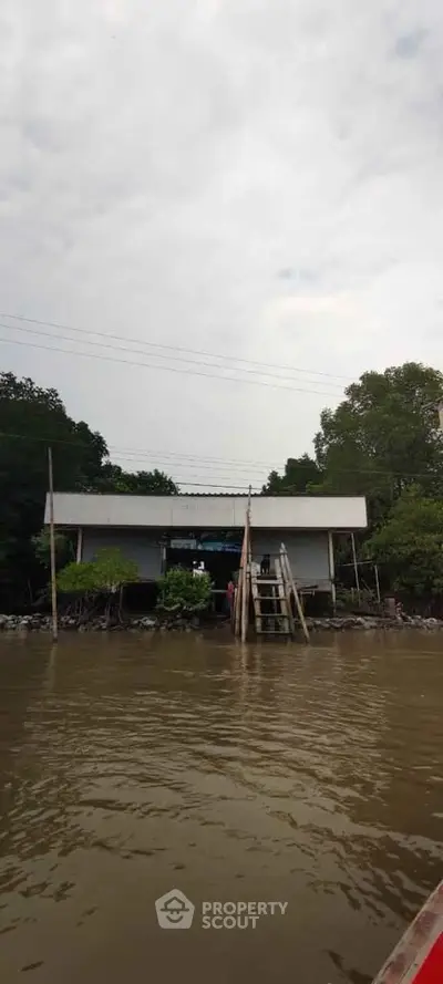 Riverside property with unique architecture and serene water view.