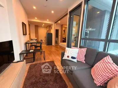 Modern living room with cozy sofa and dining area in open layout apartment