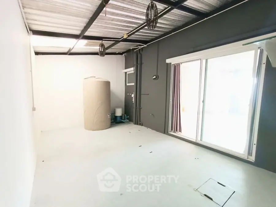 Spacious storage room with natural light and sliding glass doors