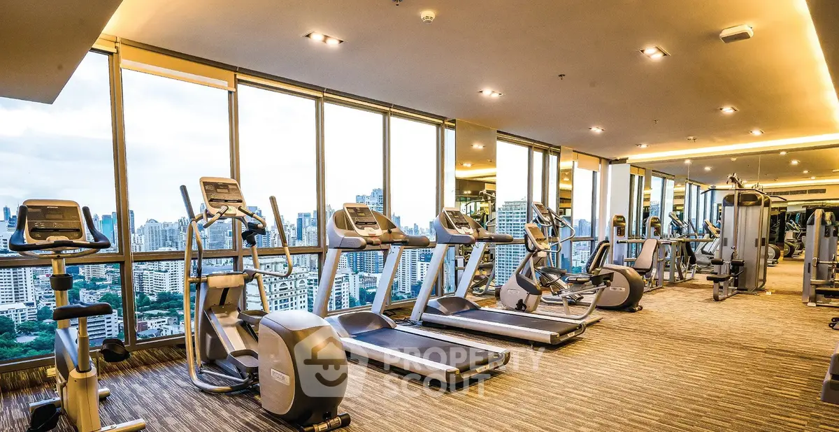 Luxurious high-rise gym with panoramic city views and modern fitness equipment.