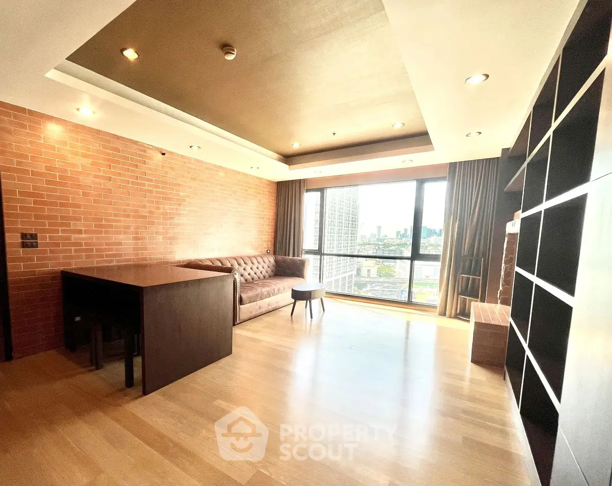 Spacious modern living room with city view and stylish brick wall design.