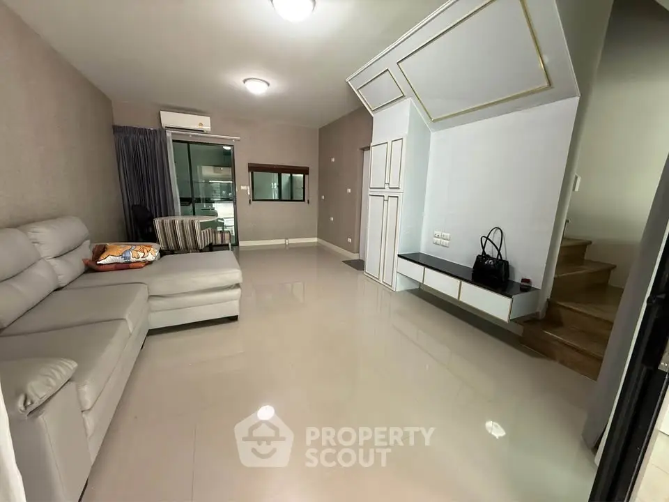 Spacious modern living room with sleek design and elegant furnishings.