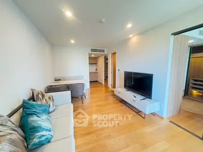 Modern living room with wooden flooring and stylish furniture in a contemporary apartment.