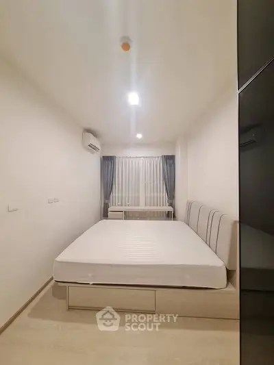 Modern minimalist bedroom with natural light and sleek furnishings