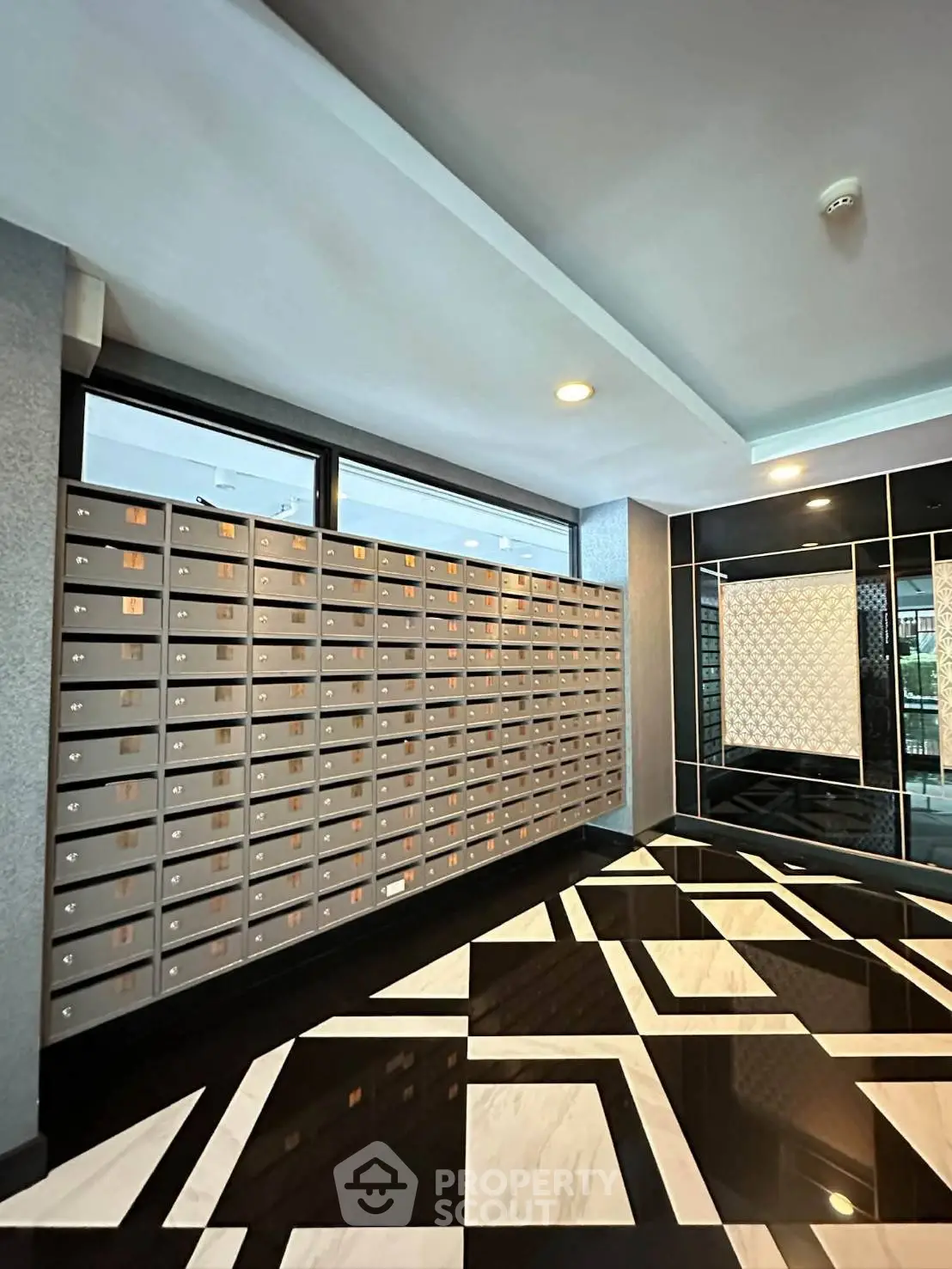 Stylish apartment lobby with modern mailboxes and geometric flooring