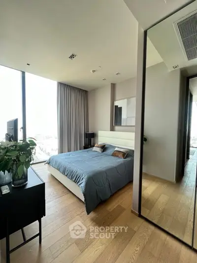 Modern bedroom with large window and stylish decor in urban apartment