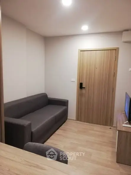 Cozy living room with modern sofa and wooden flooring