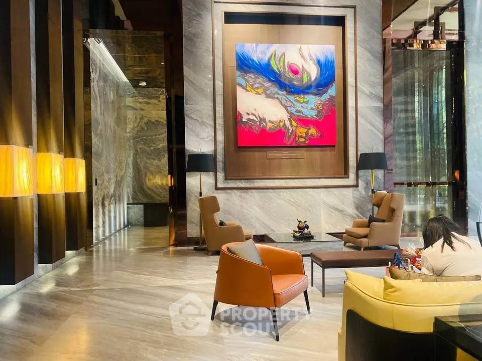 Luxurious modern lobby with elegant seating and vibrant artwork, perfect for upscale living.