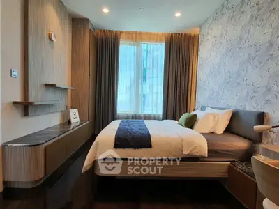 Modern bedroom with stylish decor and large window offering natural light