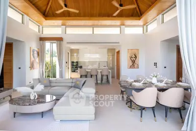 Luxurious open-plan living and dining area with modern decor and high ceilings