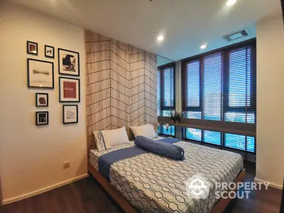 Modern bedroom with stylish decor, large windows, and cozy bedding, perfect for relaxation and comfort.