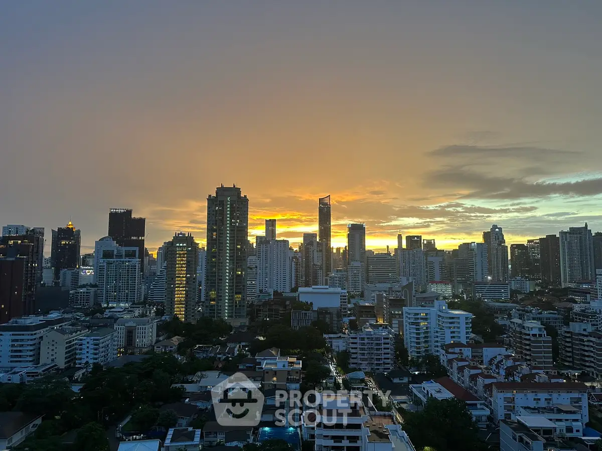 Stunning city skyline view at sunset with high-rise buildings and vibrant sky.