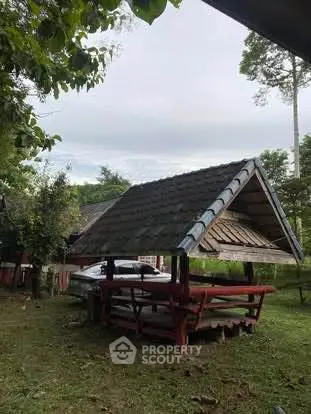 Charming outdoor gazebo in lush garden setting, perfect for relaxation.