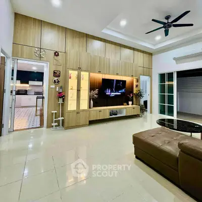 Spacious living room with modern entertainment center and cozy seating area.