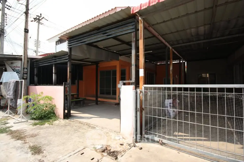 Spacious residential property with covered parking and gated entrance, ideal for family living.