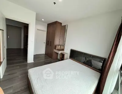 Spacious modern bedroom with wooden flooring and stylish furniture