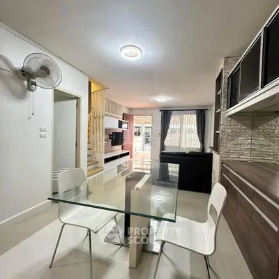 Modern living room with stylish decor and glass dining table