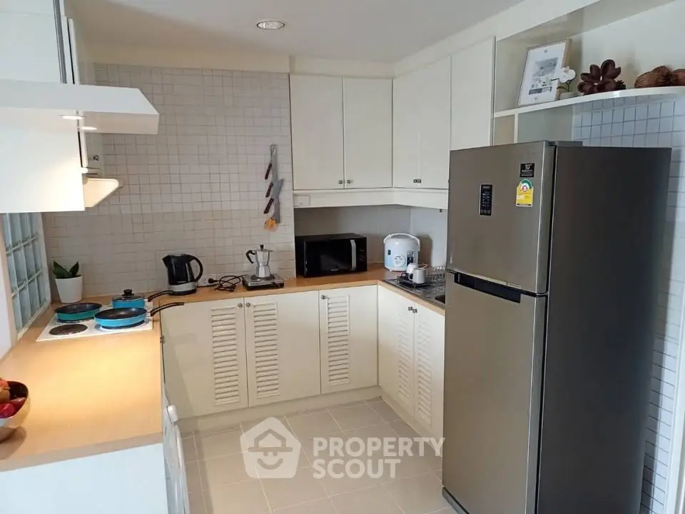 Modern kitchen with sleek appliances and ample storage space