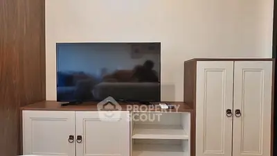 Modern living room with sleek TV stand and storage cabinets