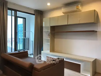 Modern living room with sleek furniture and balcony access