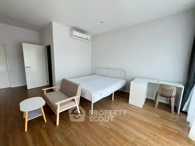 Spacious minimalist bedroom with modern furniture and natural light