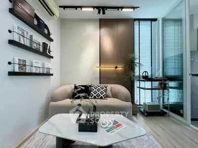Modern living room with stylish decor and natural light, featuring a cozy sofa and sleek coffee table.