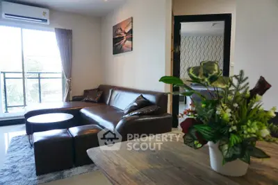 Modern living room with leather sofa and balcony view