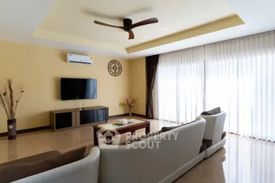 Spacious living room with modern decor and natural light