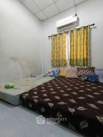 Cozy bedroom with air conditioning and comfortable bedding, perfect for relaxation.