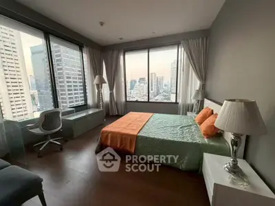 Spacious bedroom with city view in modern high-rise apartment