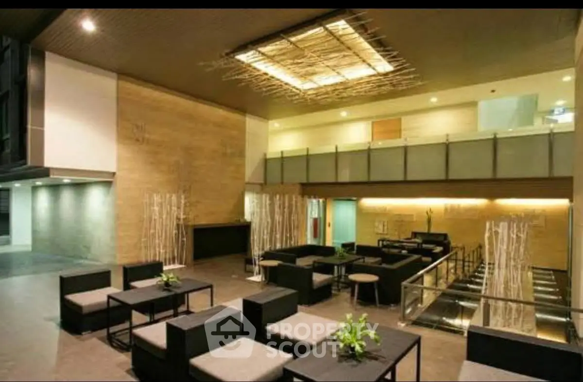 Luxurious modern building entrance with stylish seating and ambient lighting