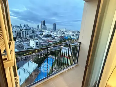 Stunning cityscape view from high-rise balcony overlooking urban skyline and pool.
