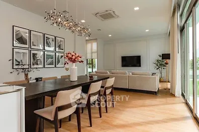 Spacious modern living room with elegant dining area and large windows for natural light.