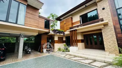 Modern architectural home exterior with wooden accents and spacious driveway