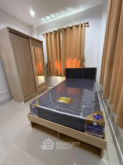 Cozy bedroom with new mattress and stylish wardrobe, perfect for modern living.