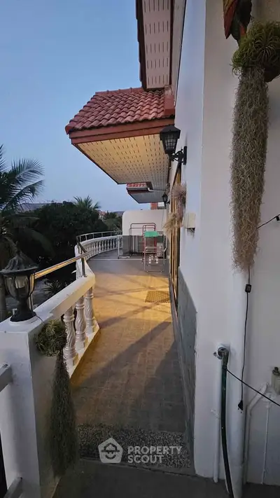 Charming balcony with elegant railing and lush greenery, perfect for relaxation and outdoor enjoyment.