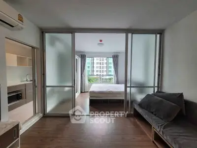 Modern apartment with sliding glass doors and cozy bedroom view