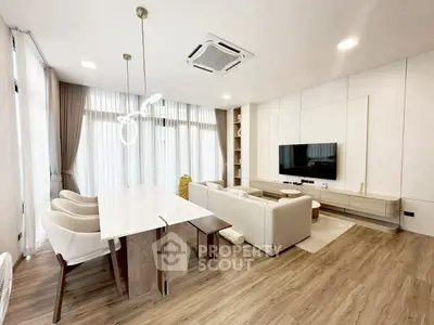 Modern open-plan living room with elegant dining area and stylish decor