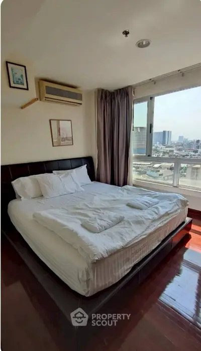 Spacious bedroom with city view and modern furnishings