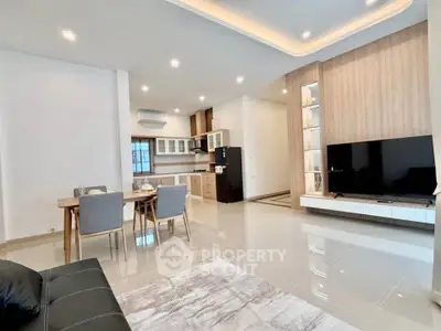 Spacious modern living room with open kitchen and sleek furnishings