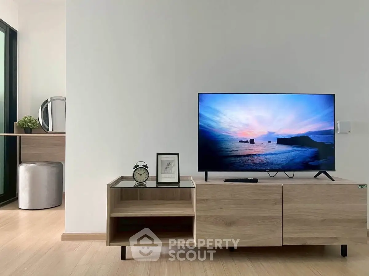 Modern living room with sleek TV setup and stylish wooden furniture