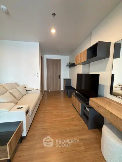 Modern living room with sleek furniture and wooden flooring