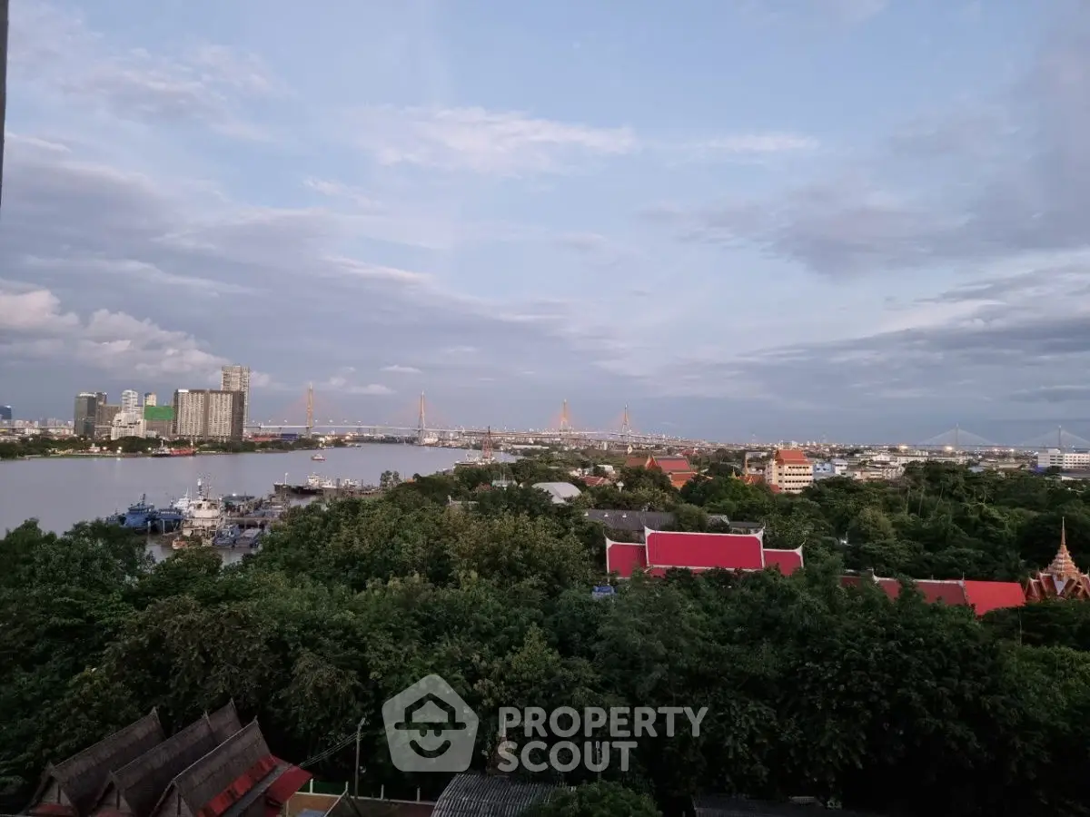 Stunning panoramic view of city skyline and river, perfect for urban living enthusiasts.