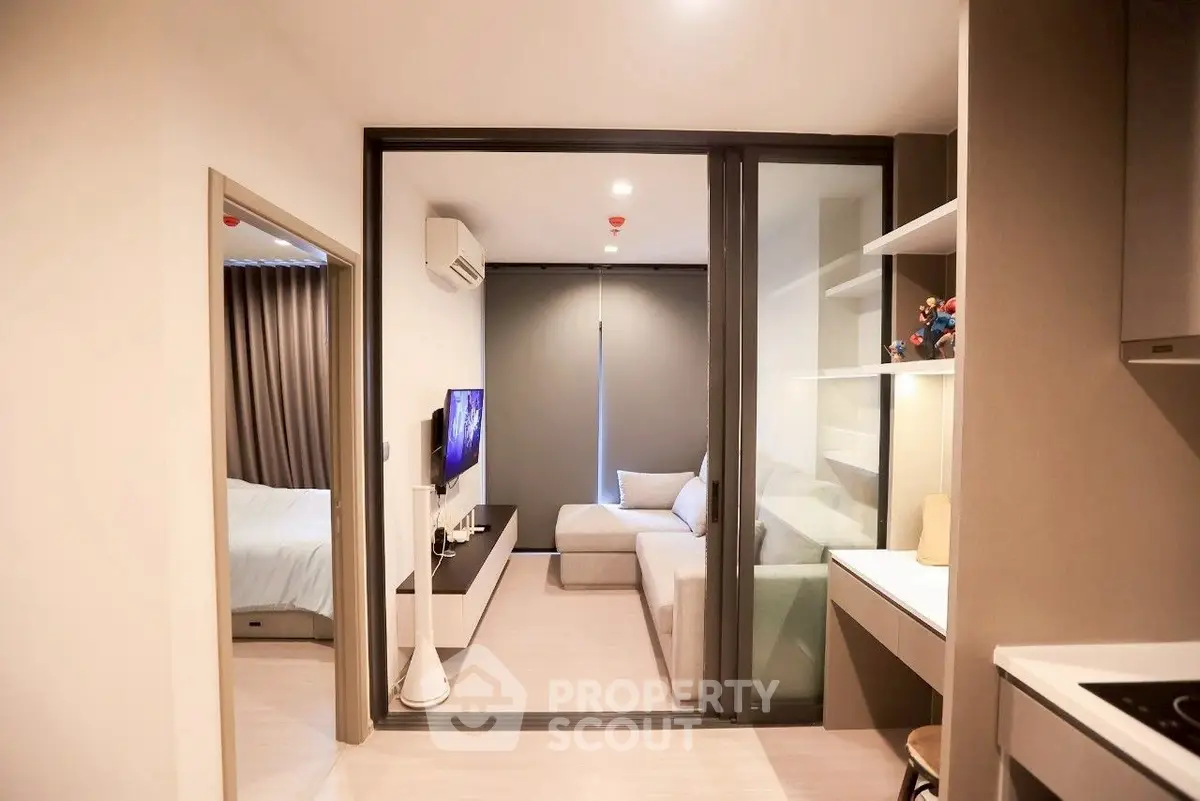 Modern apartment interior with cozy living room and stylish bedroom, featuring sleek design and natural lighting.