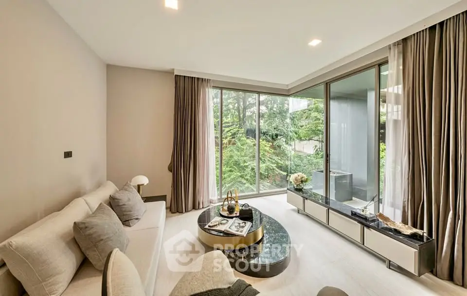 Luxurious living room with floor-to-ceiling windows and garden view