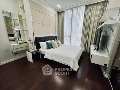 Luxurious modern bedroom with elegant decor and floor-to-ceiling windows offering stunning views.