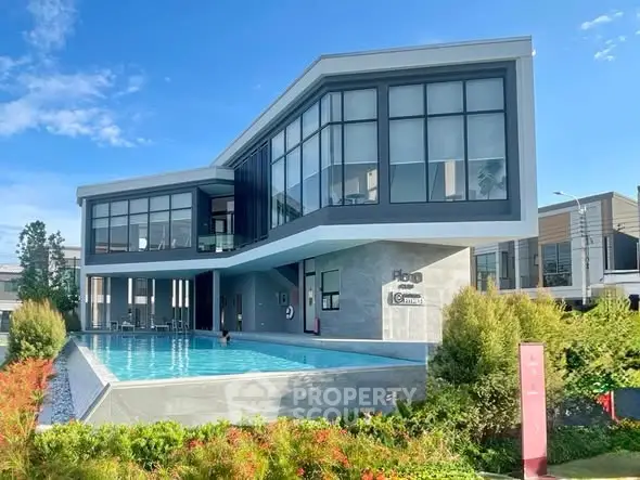 Modern architectural masterpiece with sleek design and stunning pool in lush surroundings.