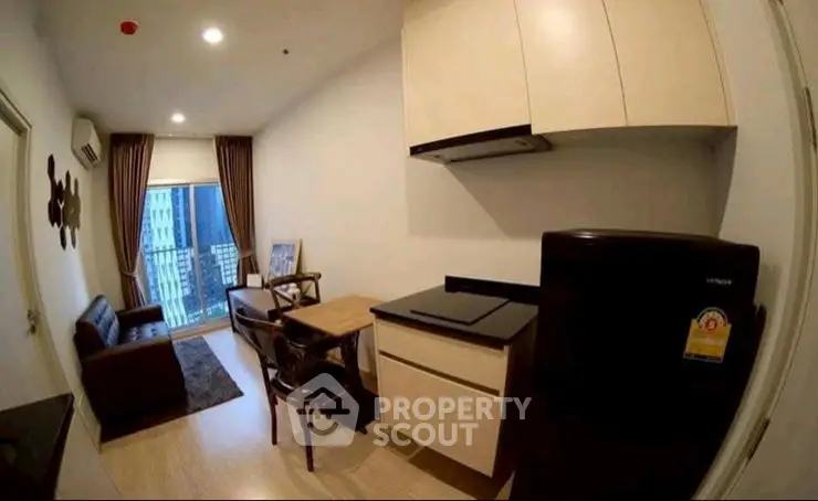 Modern apartment living room with compact kitchen and balcony view