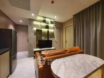 Modern living room with leather sofa and marble table, stylish lighting and sleek design.