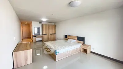 Spacious modern bedroom with sleek wooden furniture and minimalist design